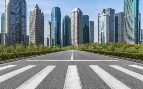 A distant cityscape with a road leading to it