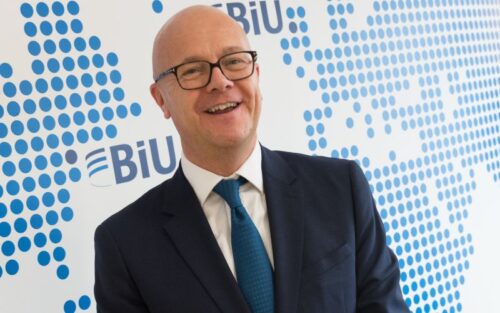 Michael Abbott, CEO in front of a blue dotted wall