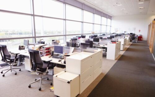 An office with empty desks and tables