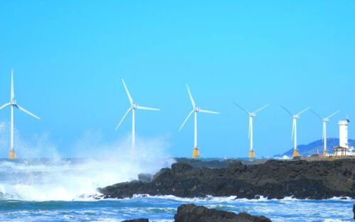 Wind turbines off a costal edge
