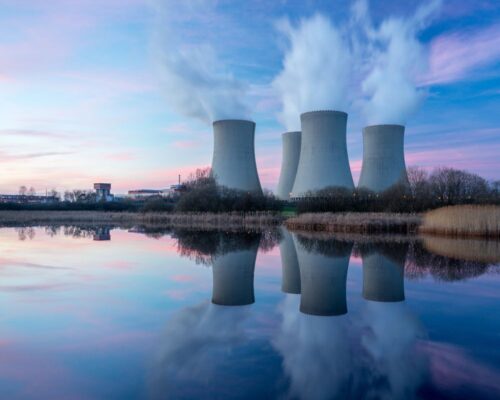 Nuclear power plant after sunset. Dusk landscape with big chimneys.