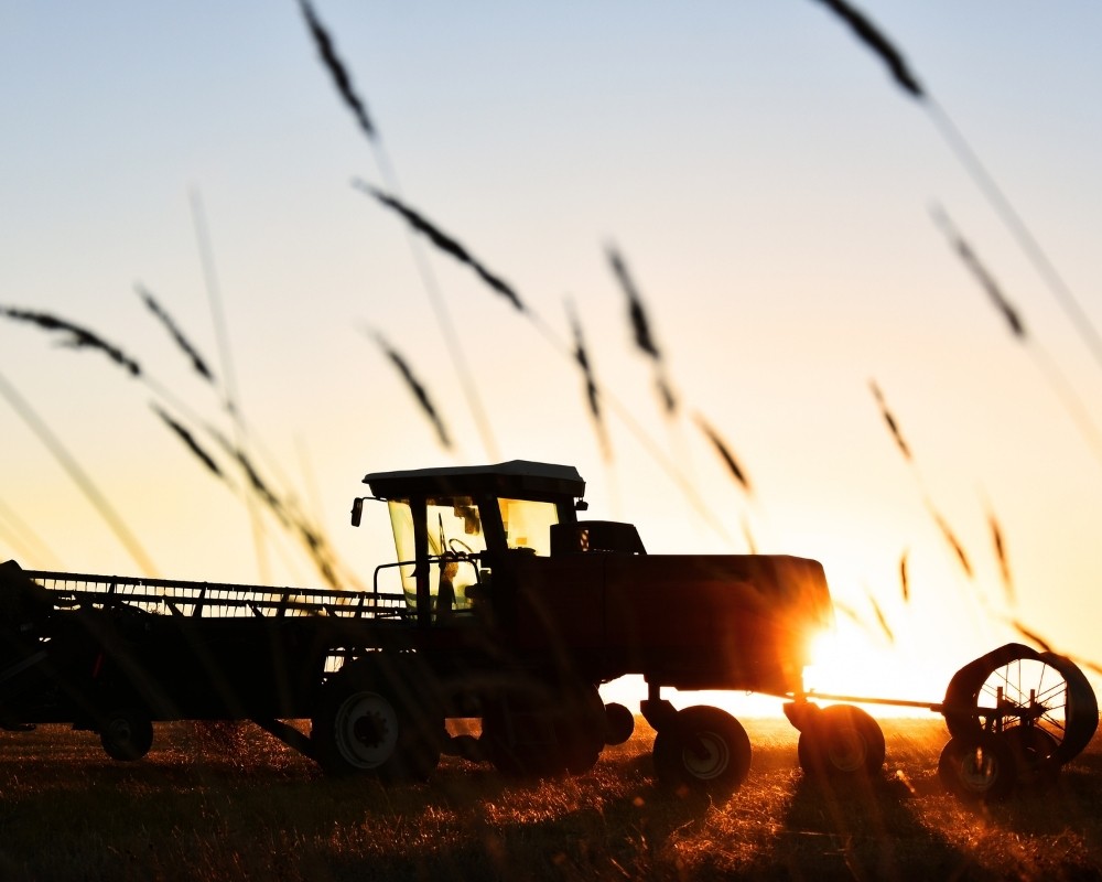 A tractor in front of a sunset