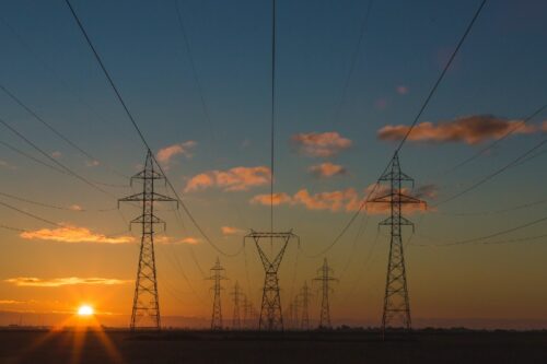 A sunrise photo of electrical power lines