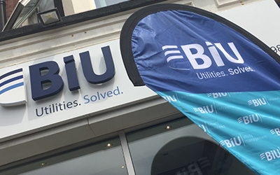 A BiU branded blue flag in front of a sign saying BiU