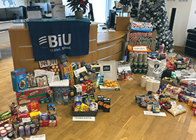 A large amount of donated food and drink in a reception area